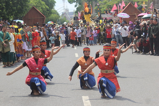 Palangka Raya City, Central Kalimantan Province, Indonesia - May 24, 2023 - Young women from the Minahasa Kawanua tribe perform traditional dances at a cultural carnival in Indonesia.