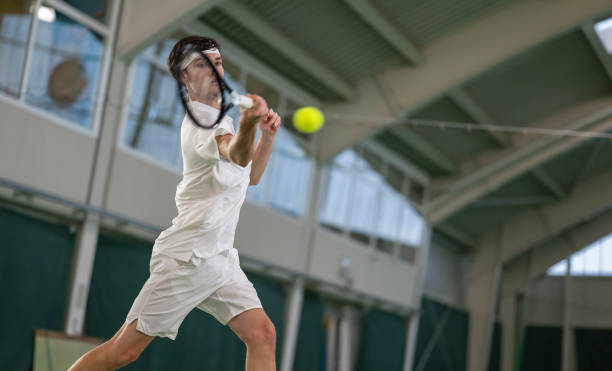 istock Male Tennis Player Hitting Ball With Racket 2078659870