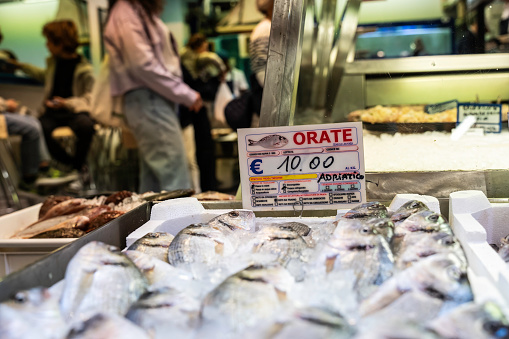 Modern and sustainable fish market with sea bream on display, highlighting fish origin label