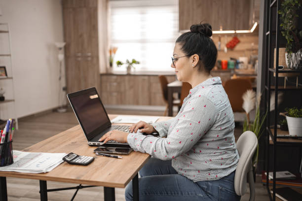 istock Caucasian woman working on laptop at home 2078694220