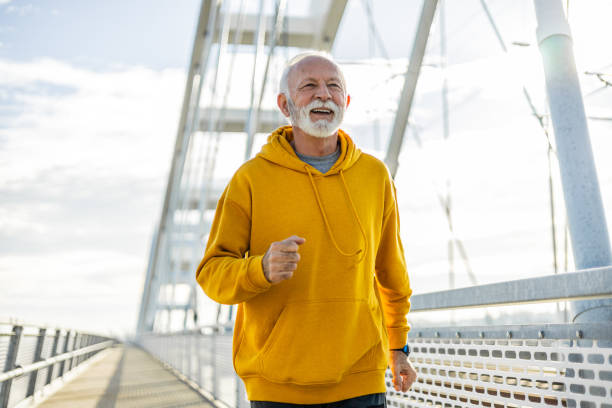istock Senior athlete jogging on the bridge 2078706031