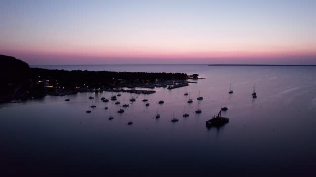 Drone shot flying over a marina in door county, Wisconsin at sunset