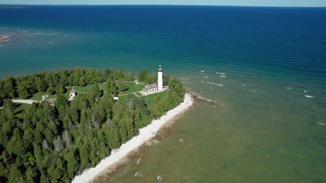 Drone aerial shot flying in towards the Old Baileys Harbor Bird Cage Lighthouse