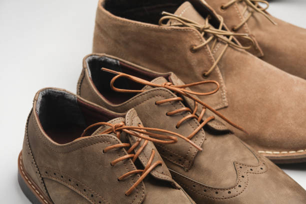 istock Brogue shoes and desert boots closeup on a white background 2078763466