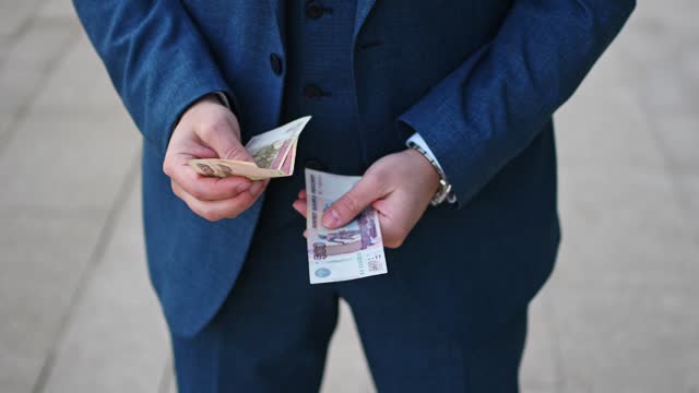 Businessman counting Russian ruble outdoors