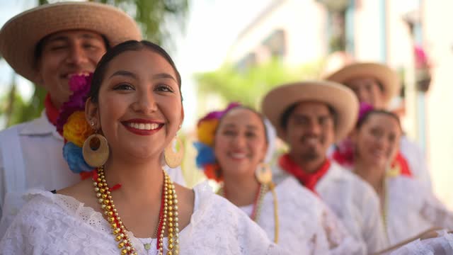 Portrait of a young woman whit dancers in traditional festival outdoors