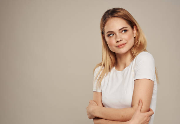 istock Romantic blonde woman on a gray background gestures with her hands Make-up on her face 2078810452