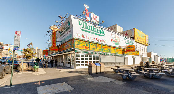 Brooklyn, New York City, USA - February 18, 2023: Facade of the waterfront Nathan's fast food stand restaurant at Coney Island closed on a winter day