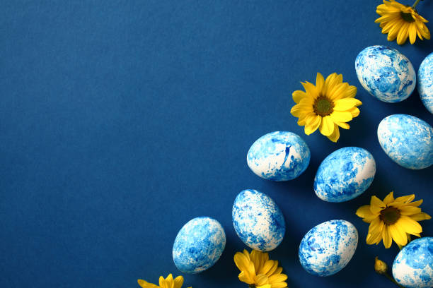 istock Blue and white Easter eggs with yellow flowers on dark blue background. Easter card template. 2078819907