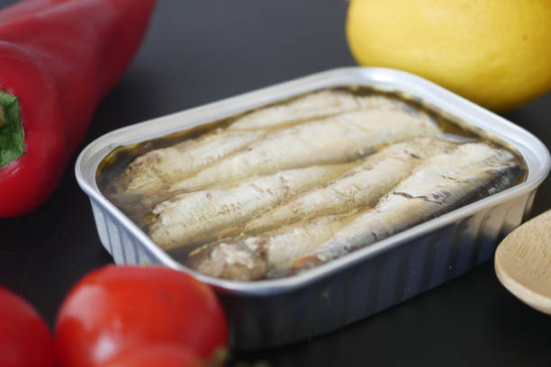 istock open tin of sardines on white tiles background. 2078820949