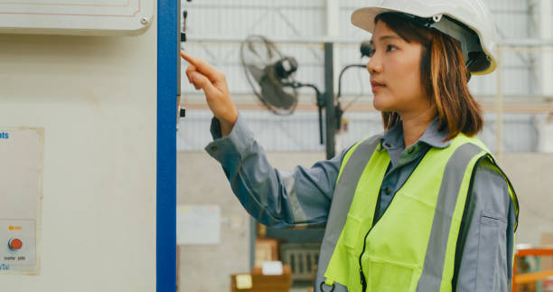 istock Professional Asian female industrial engineers operating machine keypad in manufacturing factory. Working in manufacturing plant or production plant. 2078821485