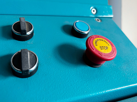 Close-up of machine part control panel star-stop push buttons