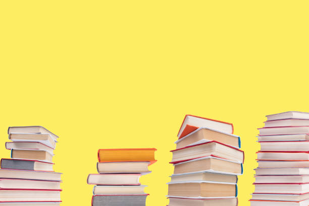 istock Composition with hardback books on wooden deck table and yellow background. Books stacking. Back to school. Copy Space. Education background. 2078835659