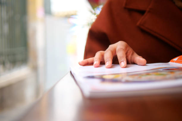Close-up of unrecognizable salesperson going through the manual