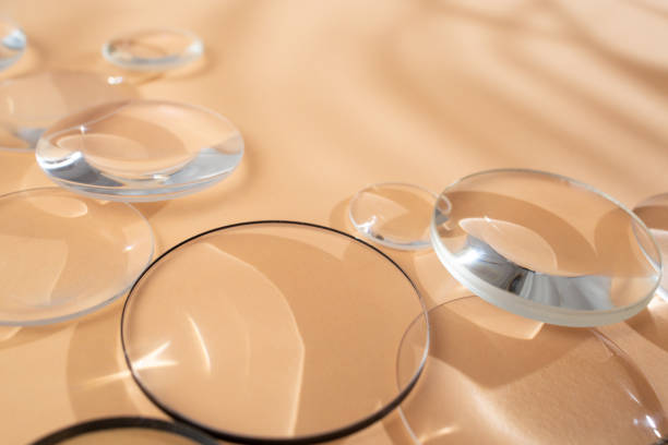 istock Clear magnifying lenses on bright cream background, with palm leaves shadows, quiet abstract backdrop 2078860211