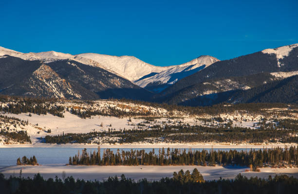 istock Beautiful view Colorado mountain range with frozen lake lit by setting sun 2078870293