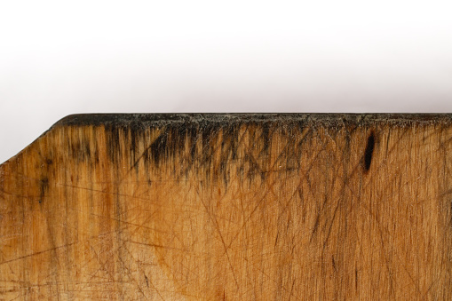 Wooden chopping board with cut marks and black mold, cloae up