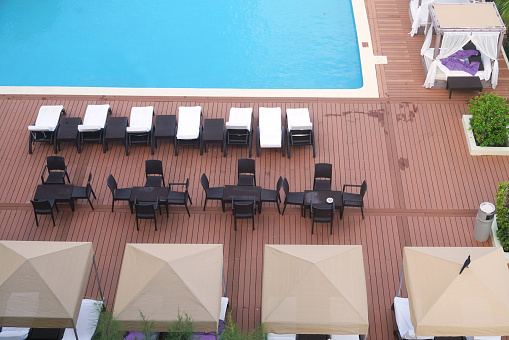 high angle view of beach chairs at the side of swimming pool