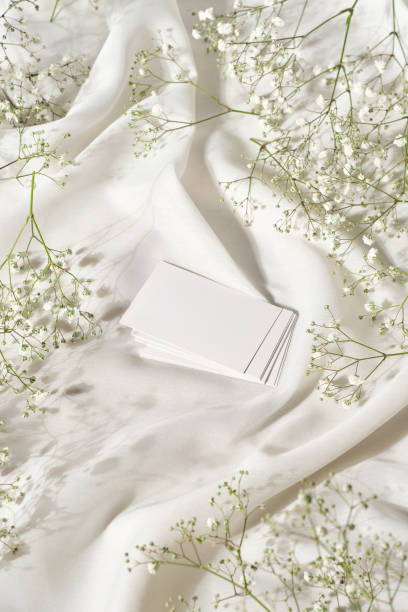 istock White blank card on a table with silk cloth and flowers 2078886123