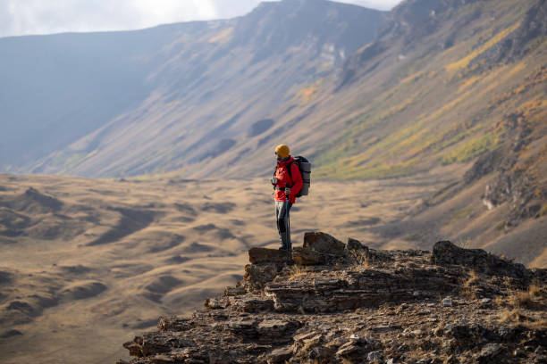 istock Hiking male ascending mountain meadow crest. 2078901335