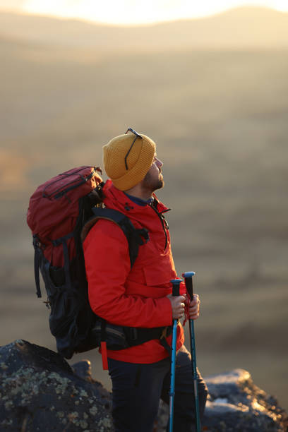 istock Hiking male ascending mountain meadow crest. 2078903403