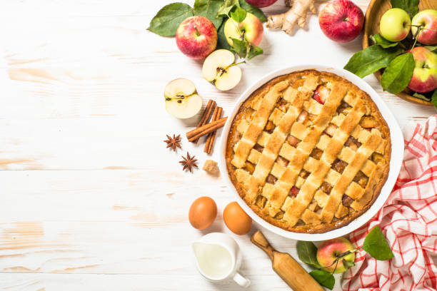 istock Apple pie with ginger and cinnamon at white wooden table. 2078921907