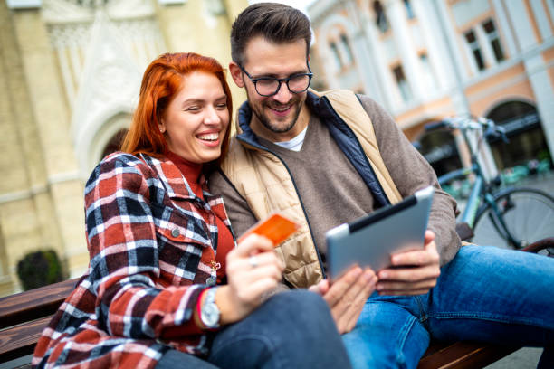 istock Trendy young couple in town using tablet and credit card. 2078928340