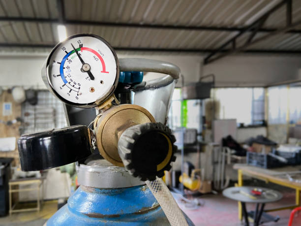 Close-up of industrial oxygen tank for welding pressure gauge and valve in factory