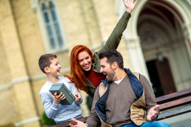 istock Young family with present outdoor. 2078932069