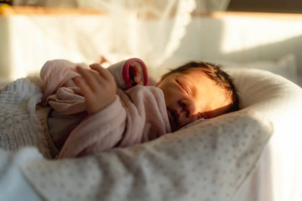 istock a newborn baby sleeping  on  bed in the sun 2078939930