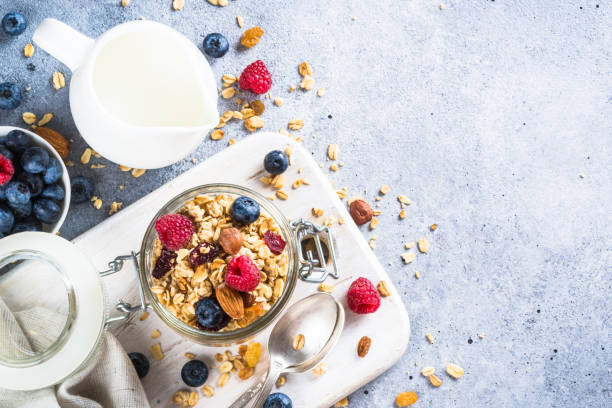 istock Granola with fresh berries in the glass jar. 2078940461