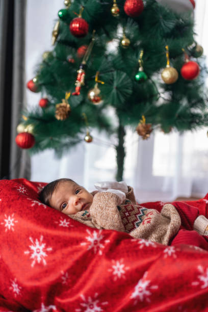 istock a newborn baby in a christmas sweater 2078940975