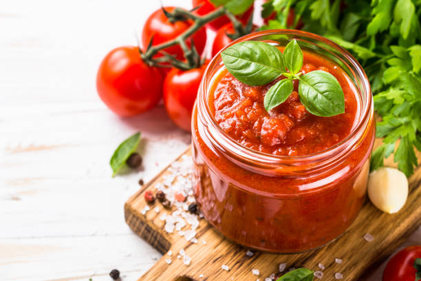 istock Tomato sauce with herbs and spices at white background. 2078945166