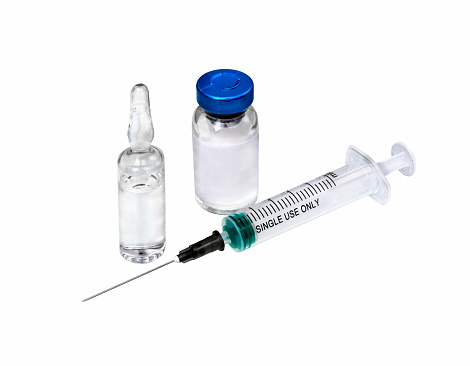 Medical syringe and ampoules isolated on white background