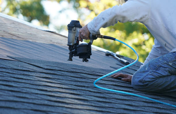 istock handyman using nail gun to install shingle to repair roof 2078951438