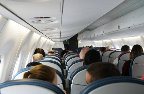 istock back side view of passengers sitting in the airplane 2078952489