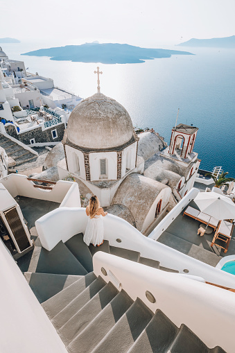 Famous Panoramic view of Santorini, Greece. White architecture, yachts and the blue sea of the island of Santorini against the background of the sea. Holidays in Greece, Santorini.