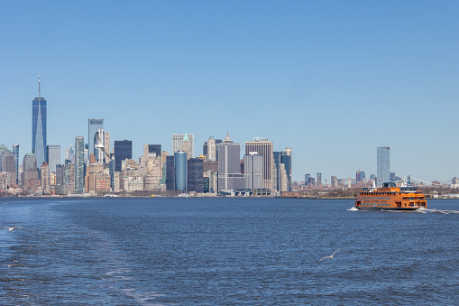 New York, NY - Febraury 19 2024:  Staten Island Ferry with the Lower Manhattan skyline in the distance