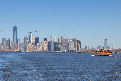 New York, NY - Febraury 19 2024:  Staten Island Ferry with the Lower Manhattan skyline in the distance