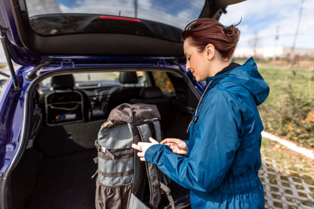 istock Woman packing backpack in car trunk 2078981071