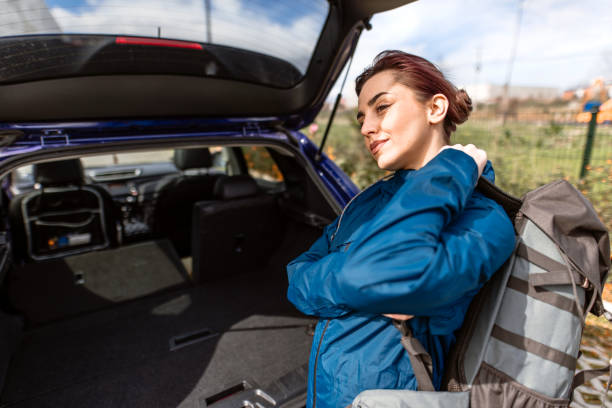 istock Woman packing backpack in car trunk 2078982174