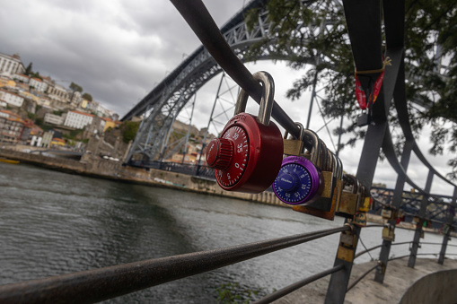 Porto Portugal - 5 September 2023 - Padlocks symbolizing love on the railing under the Luis I Bridge in Porto