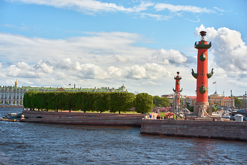 Saint Petersburg. Russia - June 02, 2023: Rostral column (lighthouse) on Spit of Vasilievsky Island, embankment Neva river. Blue cloudy sky.