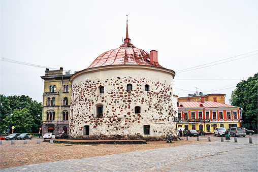 Vyborg, Leningrad Oblast, Russia - June 06, 2023: Beautiful view of the Market Square with Round Tower. It was built by Swedes in 1547-1550 as a part of the medieval town wall in Vyborg town