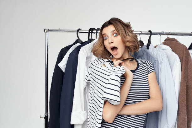istock pretty woman trying on clothes isolated background 2079007334