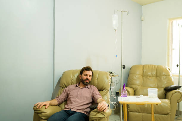 istock Smiling man getting a restore treatment with an IV drip therapy 2079018986