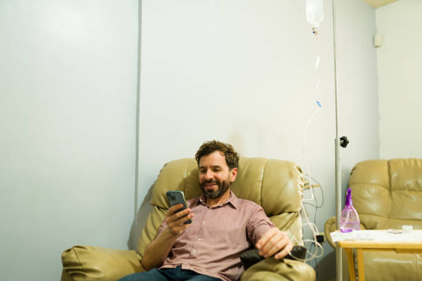 istock Happy man restoring his health getting IV drip therapy 2079020024