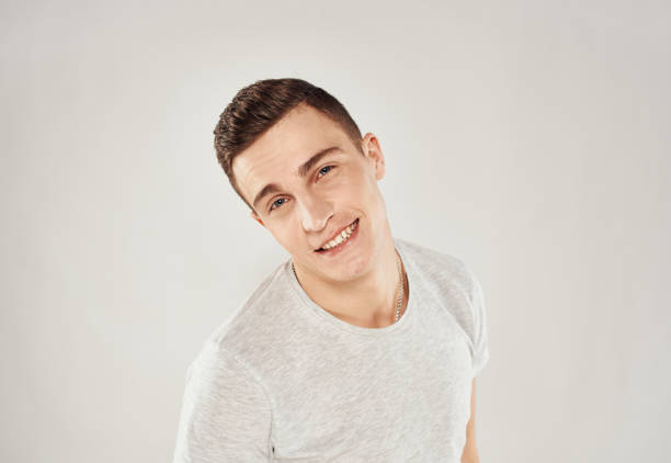 Handsome man trendy haircut white t-shirt close-up Studio. High quality photo