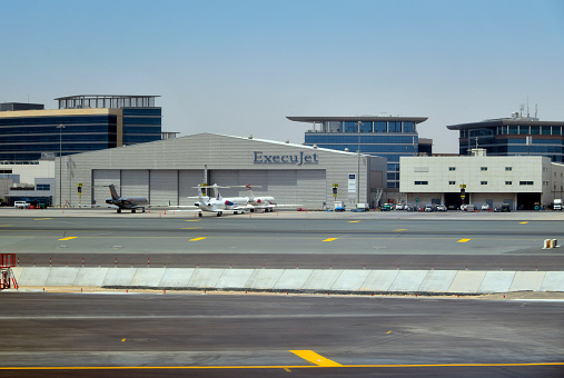 Al Garhoud district, Dubai: ExecuJet Aviation Group hangar at Dubai International Airport - business charter airline headquarters in Zurich and based at Zurich Airport. In addition to charter flights, the company also offers aircraft management, FBO services, training, buying and selling.