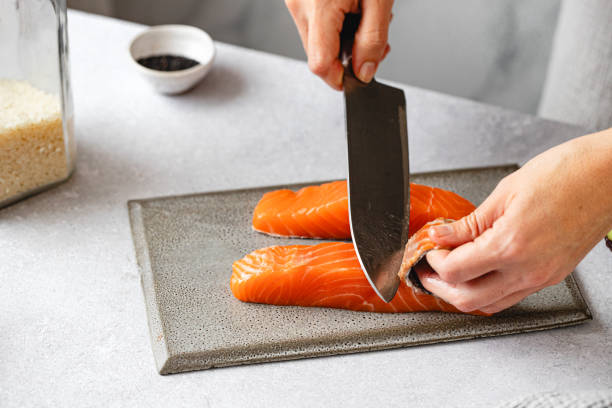 istock Close-up of chef cutting salmon fish in kitchen 2079052719
